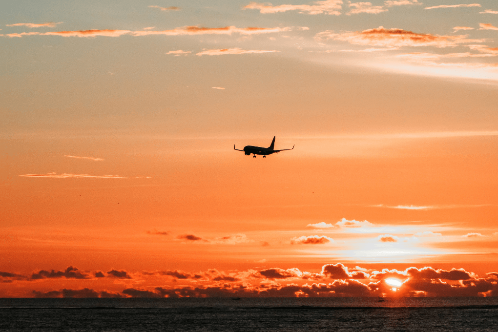 A plane flying during sunset